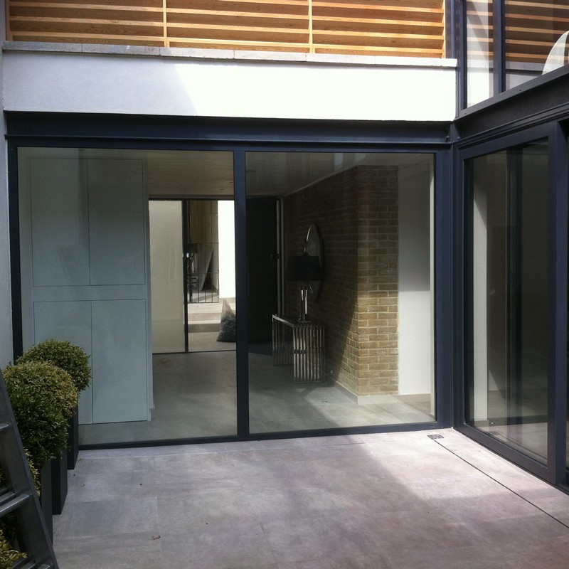 Floor-to-ceiling sliding doors opening to courtyard in Plumstead