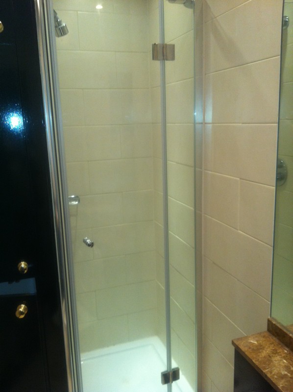Frameless glass shower enclosure with chrome fittings in Plumstead