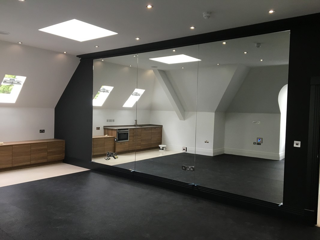 Frameless glass wall dividing loft conversion in Plumstead